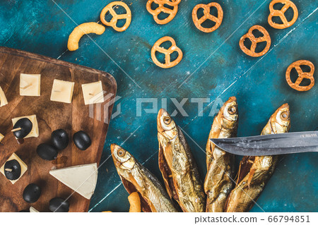 Dry fish snack with cheese, olive and crackers on the blue table 66794851