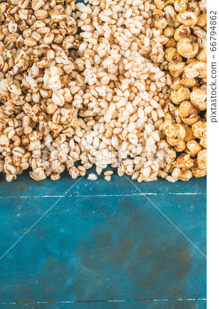 Popcorn and caramel corns on a blue background Popcorn and caramel corns on a blue background 66794862
