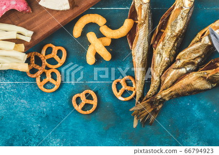 Pretzel biscuits with smoked fish on the blue table Pretzel biscuits with smoked fish on the blue table 66794923