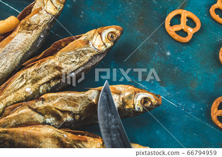 Crackers with smoked fish on the blue background Crackers with smoked fish on the blue background 66794959