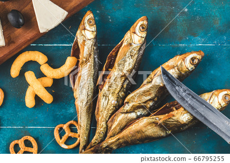 Crackers with smoked fish on the blue table Crackers with smoked fish on the blue table 66795255