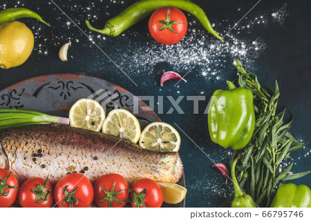 Raw fish meat with green chilies, lemon and tomatoes, top view Raw fish meat with green chilies, lemon and tomatoes, top view 66795746