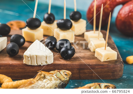 Black marinated olives with variety of cheese Black marinated olives with variety of cheese 66795824
