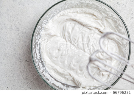 Cooking cream for cake in glass bowl and mixer. Cooking cream for cake in glass bowl and mixer. 66796281