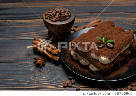 Classic tiramisu dessert on ceramic plate on wooden background Classic tiramisu dessert on ceramic plate on wooden background 66796905