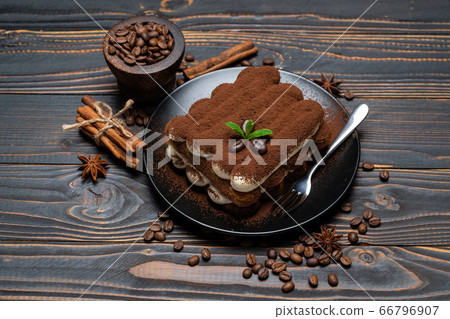 Classic tiramisu dessert on ceramic plate on wooden background Classic tiramisu dessert on ceramic plate on wooden background 66796907