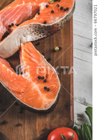 Salmon fillet with black peppers on a wooden board Salmon fillet with black peppers on a wooden board 66797021