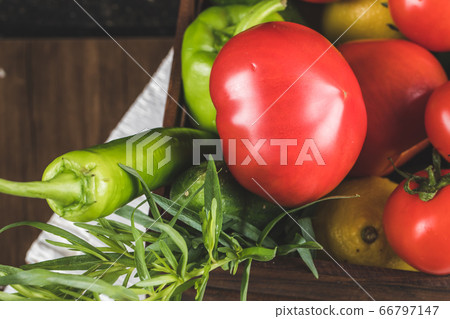 Vegetable container with tomatoes, green chilies and rosemary 66797147
