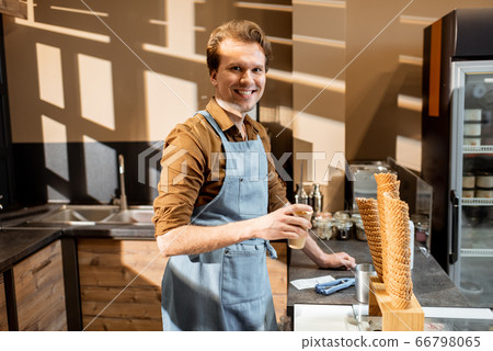 Handsome seller in the pastry shop or cafe 66798065