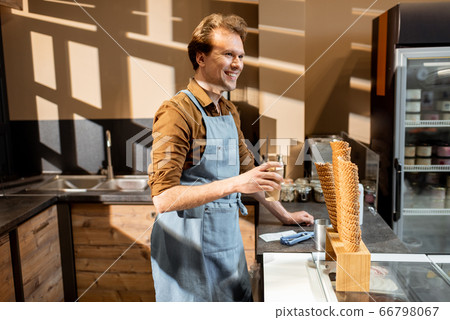 Handsome seller in the pastry shop or cafe 66798067