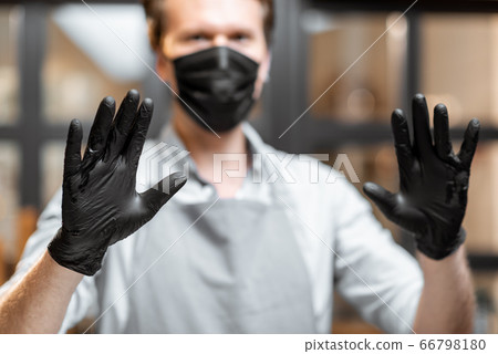 Salesman in protective wear in the cafe during a pandemic Salesman in protective wear in the cafe during a pandemic 66798180