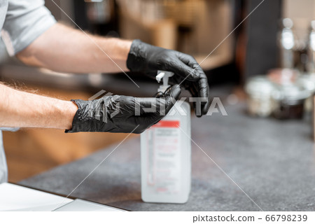 Seller disinfecting hands Seller disinfecting hands 66798239