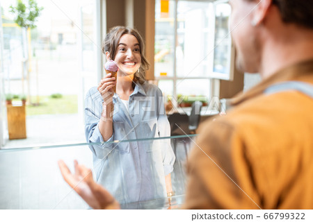 Man selling ice cream for a young woman Man selling ice cream for a young woman 66799322
