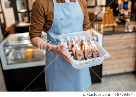 Seller with ice cream on a stick 66799394
