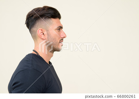 Closeup profile view of young handsome bearded Persian man 66800261