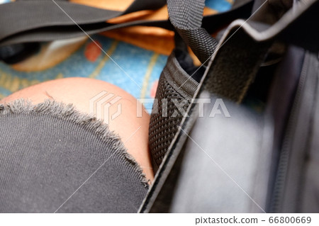 Mans leg with torn jeans, hip hop fashion style, accessories, and bag. Street fashion, backpacker, wanderer, traveller, journey, skateboarding, streetwear, aboard, transport or clothing brand concept. Mans leg with torn jeans, hip hop fashion style, accessories, and bag. Street fashion, backpacker, wanderer, traveller, journey, skateboarding, streetwear, aboard, transport or clothing brand concept. 66800669