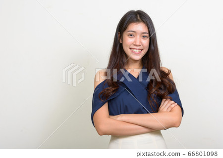 Portrait of happy young Asian businesswoman smiling with arms crossed Portrait of happy young Asian businesswoman smiling with arms crossed 66801098