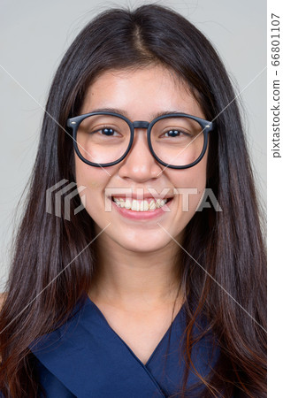 Face of happy young beautiful Asian businesswoman with eyeglasses smiling 66801107