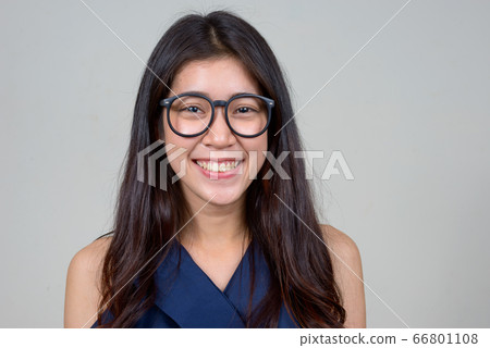 Face of happy young beautiful Asian businesswoman with eyeglasses smiling 66801108