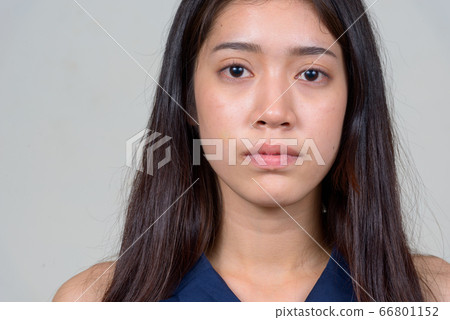 Face of young beautiful Asian businesswoman looking at camera Face of young beautiful Asian businesswoman looking at camera 66801152