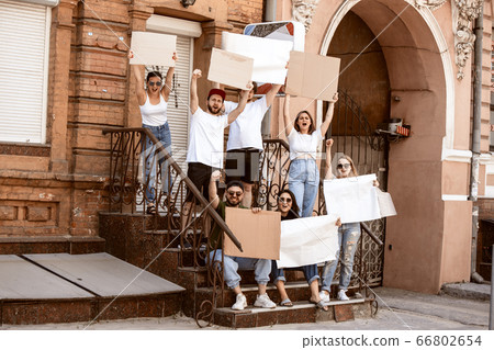 Diverse group of people protesting with blank signs. Protest against human rights, abuse of freedom, social issues 66802654