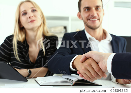 Business people shaking hands during meeting in office Business people shaking hands during meeting in office 66804285