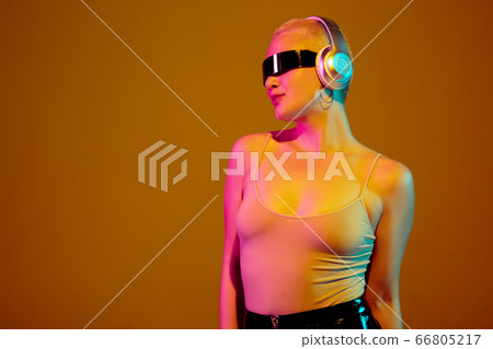 Portrait of young caucasian woman in fashionable eyewear on brown background with copyspace, unusual and freaky appearance Portrait of young caucasian woman in fashionable eyewear on brown background with copyspace, unusual and freaky appearance 66805217