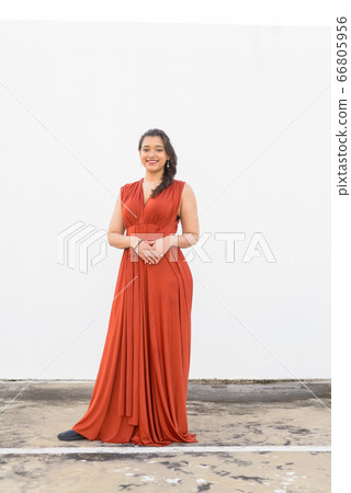 Full body shot of happy young beautiful Indian woman smiling outdoors Full body shot of happy young beautiful Indian woman smiling outdoors 66805956