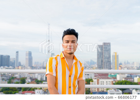 Young handsome multi ethnic man against view of the city 66806177