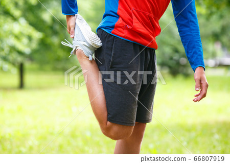 Sport and healthy lifestyle concept - jogger man stretcing muscles. Close up view of a legs. 66807919
