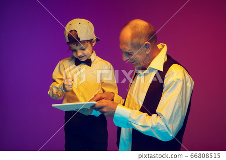 Senior man having fun and spending time together with boy, grandson. Joyful elderly lifestyle concept Senior man having fun and spending time together with boy, grandson. Joyful elderly lifestyle concept 66808515