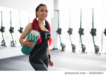 Woman massaging foam roll leg gym myofascial 66808863