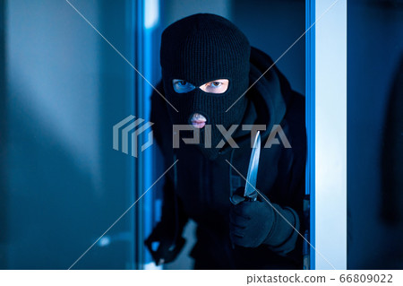 Criminal breaking in an apartment holding knife Criminal breaking in an apartment holding knife 66809022