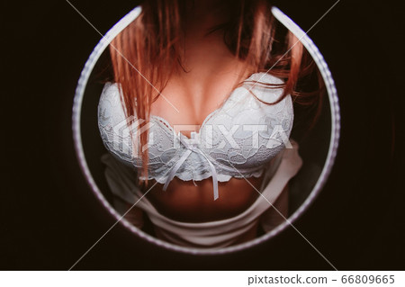 Woman breast in uplift on a black background. Woman breast in uplift on a black background. 66809665