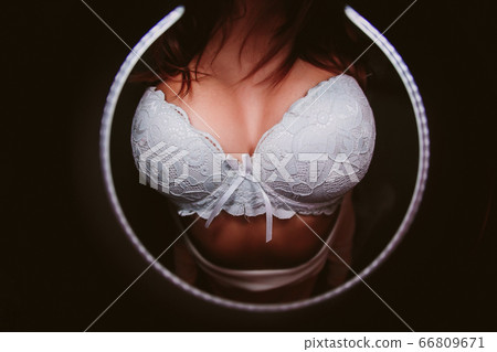 Woman breast in uplift on a black background. Woman breast in uplift on a black background. 66809671