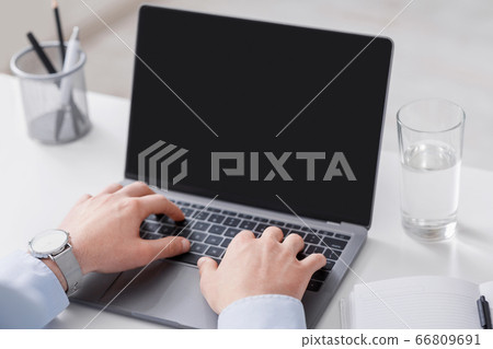 Man works at home. Hands of businessman typing on laptop with blank screen 66809691