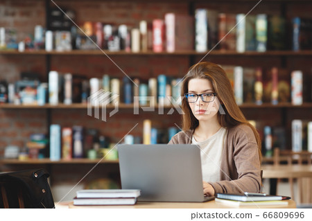 Female freelancer connecting to internet. Blogger writing new article. 66809696