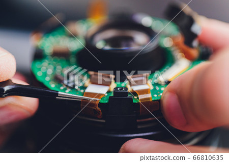 Precision prime optical dslr lens service, adjustment and alignment. Camera lens repair set in photo engineer workplace. Maintenance support of photographic photo camera lens. 66810635