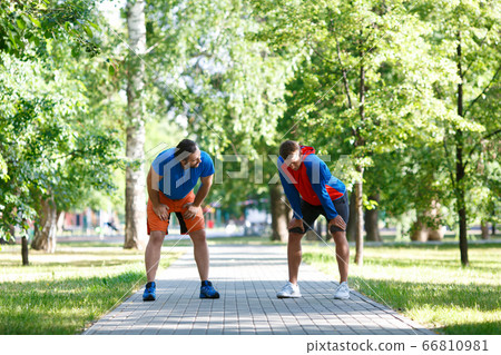 Two friends having rest after running. 66810981