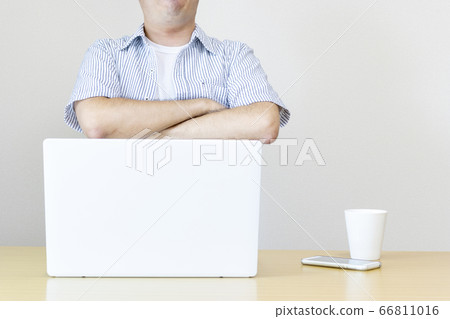 A man at home working on a laptop in plain clothes and thinking. Image of working from home and side business 66811016