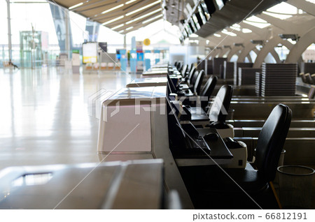 Empty check-in row desks in international airport Empty check-in row desks in international airport 66812191