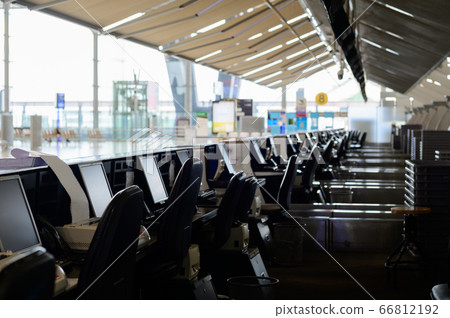 Row of empty check-in desks with computer monitors at the airport Row of empty check-in desks with computer monitors at the airport 66812192