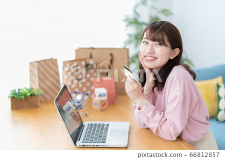 A young woman enjoying online shopping 66812857
