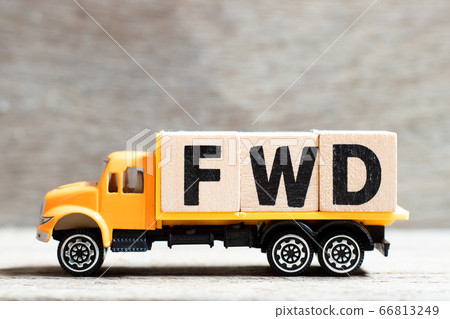 Truck hold letter block in word FWD (Abbreviation of forward) on wood background Truck hold letter block in word FWD (Abbreviation of forward) on wood background 66813249
