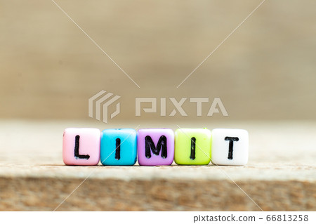 Colorful bead with black letter in word limit on wood background Colorful bead with black letter in word limit on wood background 66813258