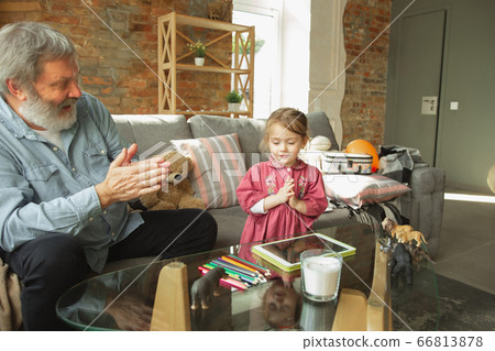 Grandfather and child playing together at home. Happiness, family, relathionship, education concept. Grandfather and child playing together at home. Happiness, family, relathionship, education concept. 66813878