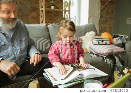 Grandfather and child playing together at home. Happiness, family, relathionship, education concept. Grandfather and child playing together at home. Happiness, family, relathionship, education concept. 66813920