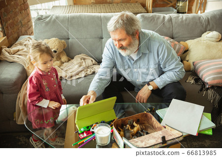 Grandfather and child playing together at home. Happiness, family, relathionship, education concept. 66813985