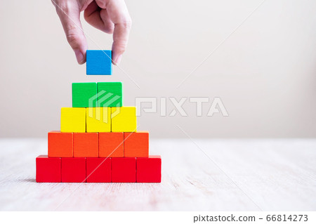 Man hand holding blue color cube block over Man hand holding blue color cube block over 66814273