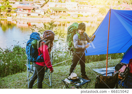 Couple Enjoying Camping Holiday in Countryside. Camp in the mountains near of the lake 66815042